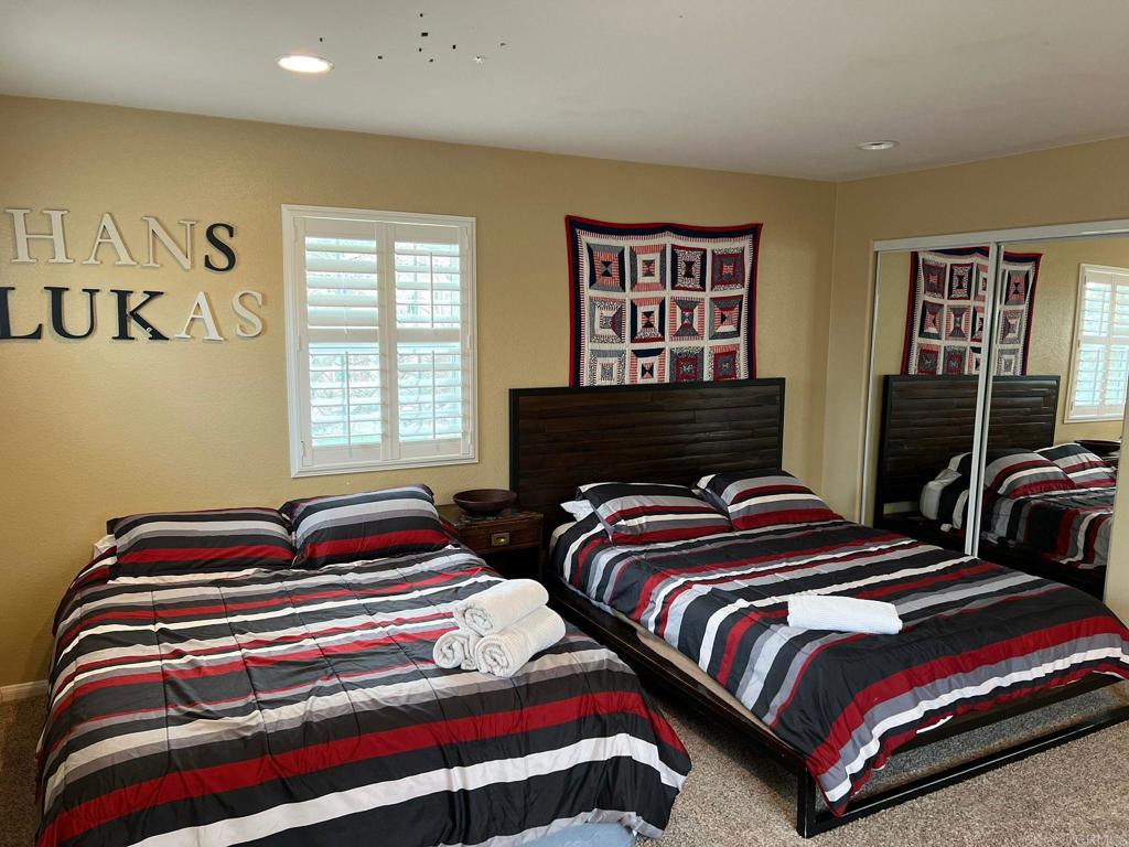 2436 Crooked Trail Road Chula Vista, CA 91914 - Photo 29 of 47 a bedroom with two beds and a window
