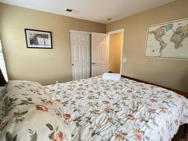 a bedroom with a bed and a dresser