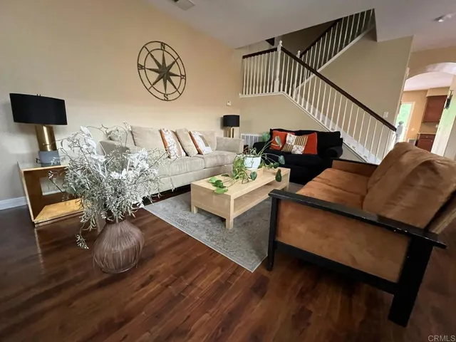 a living room with furniture and wooden floor