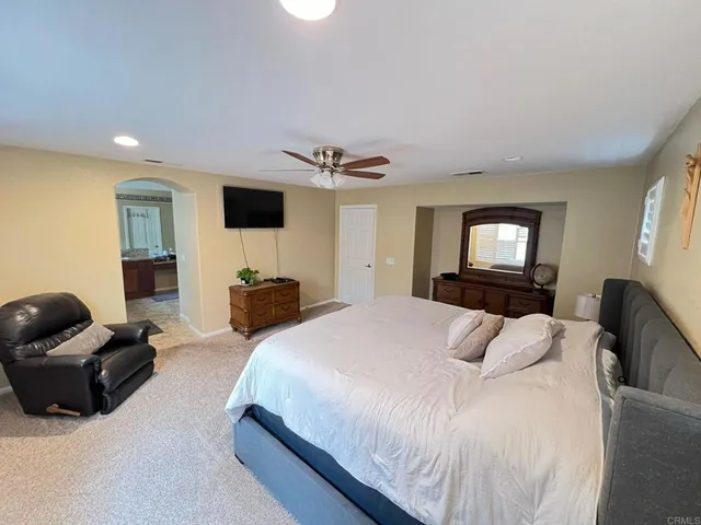 a bedroom with a bed and a dresser