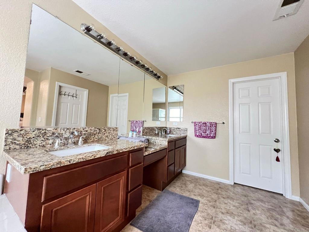2436 Crooked Trail Road Chula Vista, CA 91914 - Photo 37 of 47 a bathroom with a sink and a mirror