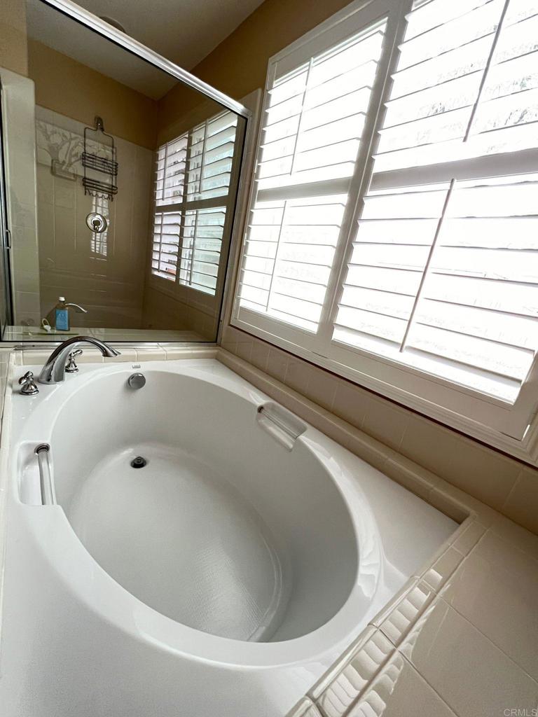 2436 Crooked Trail Road Chula Vista, CA 91914 - Photo 38 of 47 a bathroom with a bathtub and next to a window