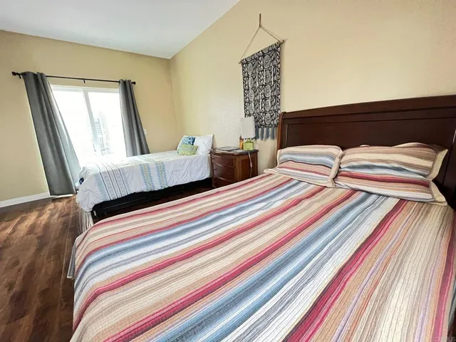 a bedroom with two beds and a flat screen tv