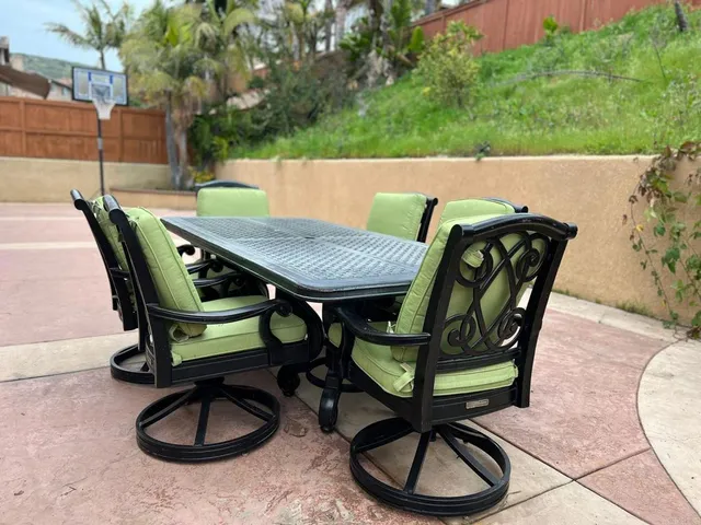 a view of a patio with a table and chairs