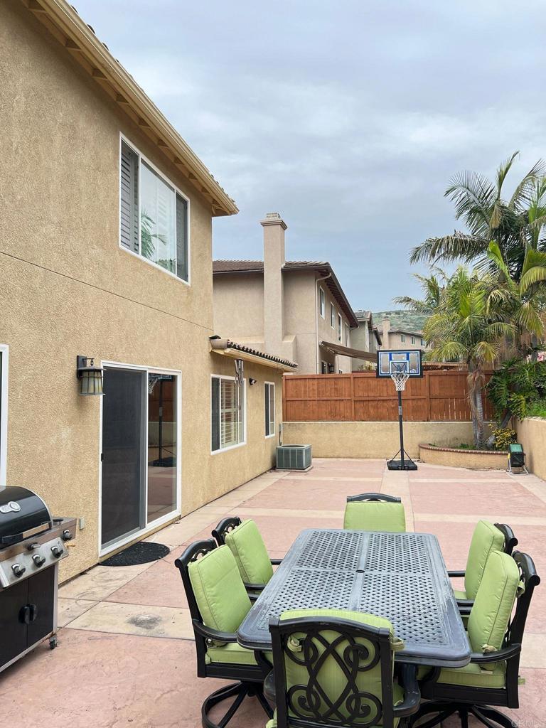 2436 Crooked Trail Road Chula Vista, CA 91914 - Photo 45 of 47 a view of a patio with table and chairs with wooden floor and fence