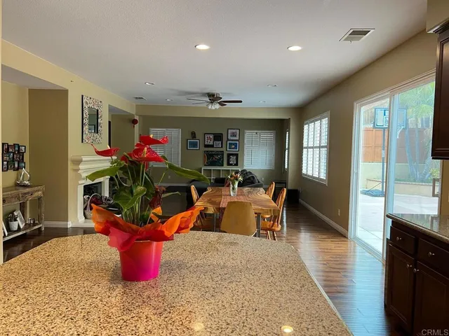 a living room with furniture a flat screen tv and a dining table