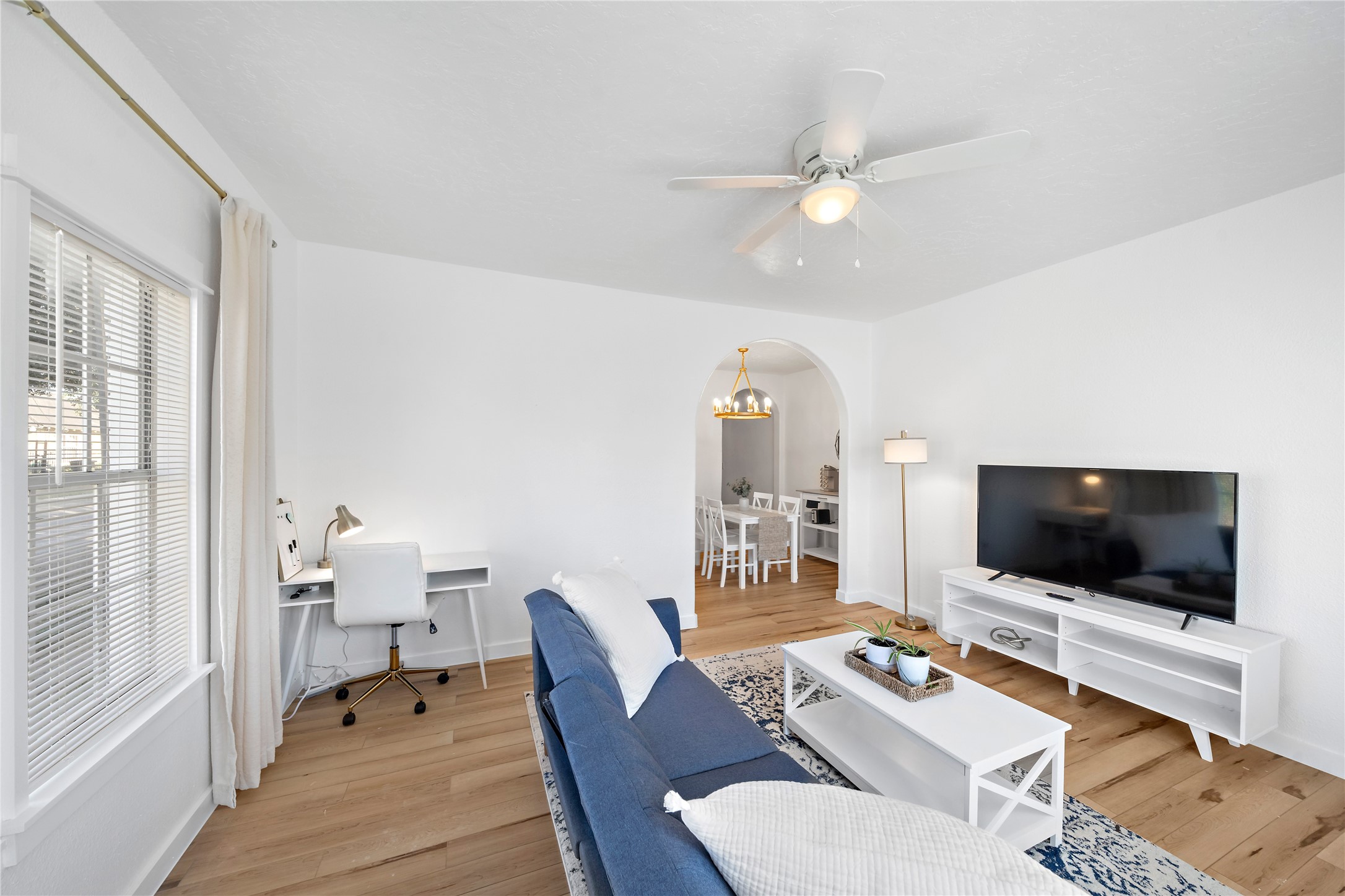 3901 Dallas Street, Unit B Houston, TX 77023 - Photo 5 of 32 a living room with furniture a flat screen tv and a floor to ceiling window
