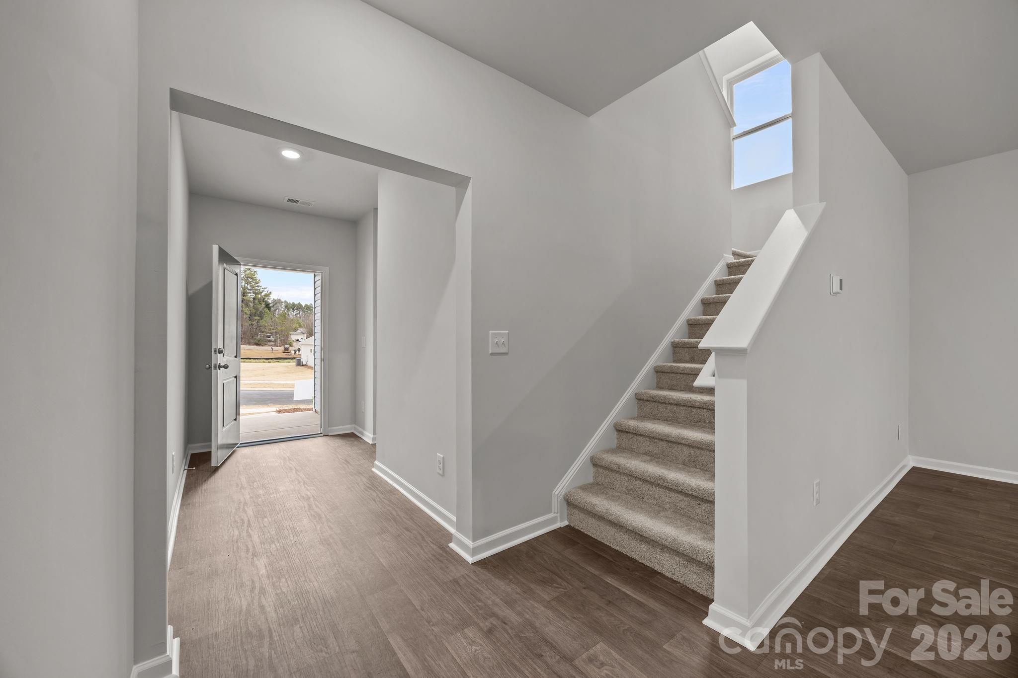 2680 Trawler Way Kannapolis, NC 28083 - Photo 6 of 16 a view of a hallway with entryway wooden floor and front door