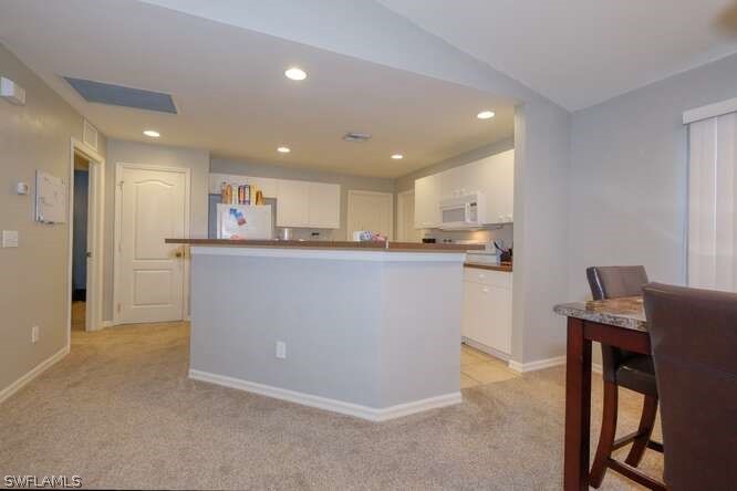2927 4th Street Southwest Lehigh Acres, FL 33976 - Photo 11 of 19 a kitchen with stainless steel appliances granite countertop a refrigerator sink and wooden cabinets