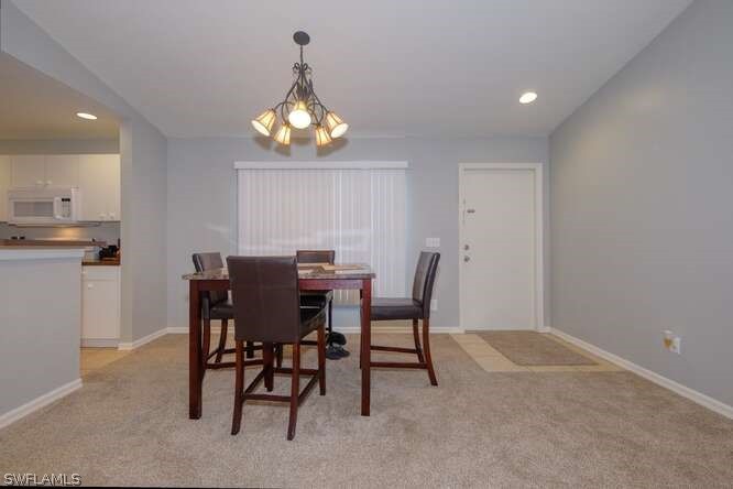 2927 4th Street Southwest Lehigh Acres, FL 33976 - Photo 12 of 19 a view of a dining room with furniture and chandelier