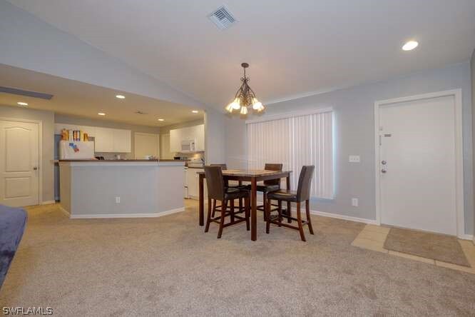 2927 4th Street Southwest Lehigh Acres, FL 33976 - Photo 13 of 19 a view of a dining room with furniture and chandelier