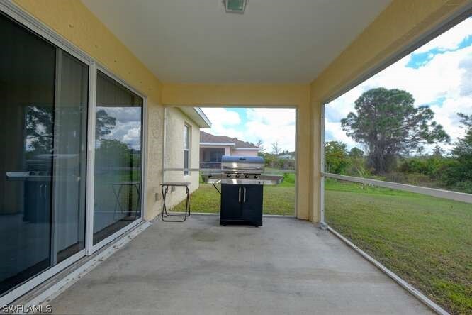 2927 4th Street Southwest Lehigh Acres, FL 33976 - Photo 15 of 19 a view of a porch with furniture and garden