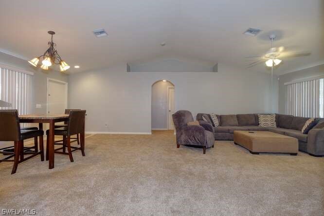 2927 4th Street Southwest Lehigh Acres, FL 33976 - Photo 4 of 19 a living room with furniture a chandelier and a dining table