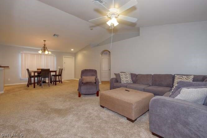 2927 4th Street Southwest Lehigh Acres, FL 33976 - Photo 5 of 19 a living room with furniture and a chandelier