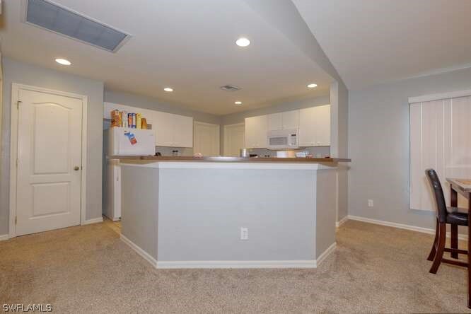 2927 4th Street Southwest Lehigh Acres, FL 33976 - Photo 7 of 19 a room with kitchen island a sink stainless steel appliances and cabinets
