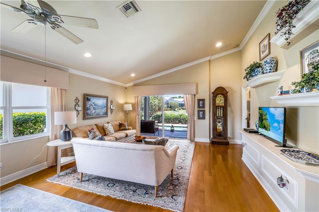 9330 Springview Loop Estero, FL 33928 - Photo 3 of 35 a living room with furniture a flat screen tv and a large window