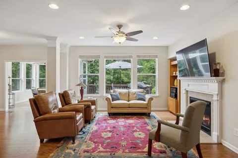 a living room with furniture a fireplace and a large window
