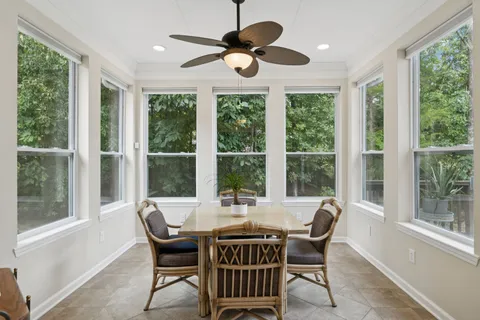 a dining room with furniture a chandelier and wooden floor