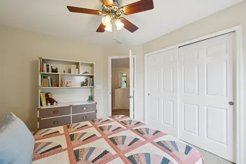 a bedroom with bed and a chandelier