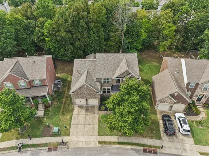an aerial view of a house with yard and parking