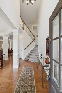 a view of entryway and hall with wooden floor