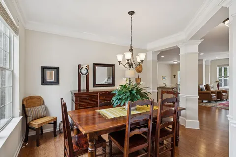 a view of a dining room with furniture wooden floor and chandelier