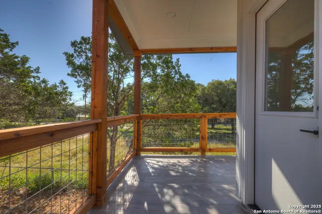 a view of a small deck with flat screen tv