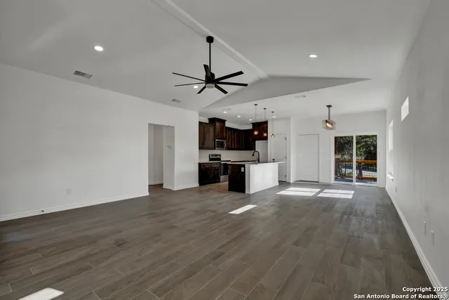 a view of a kitchen with a sink and a stove top oven