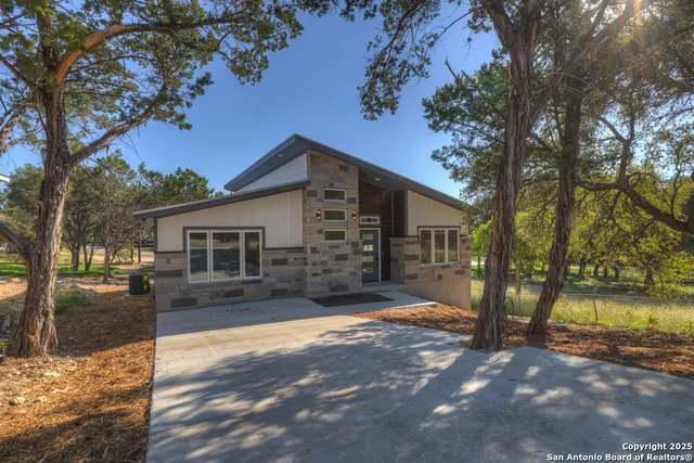 a view of a house with a yard covered in snow