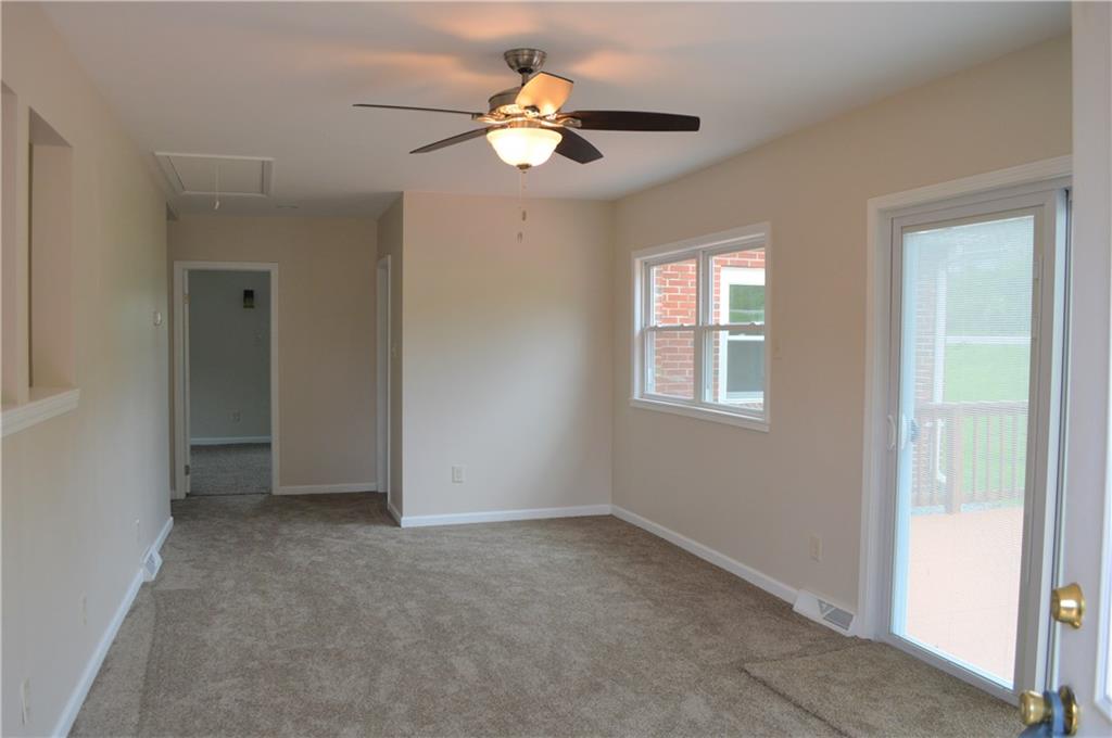 880 Lone Pine Road Amity, PA 15311 - Photo 3 of 25 New carpet, windows , ceiling fan and sliding glass door with built-in blinds.