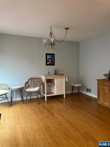 a view of a livingroom with furniture wooden floor and windows