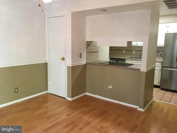a kitchen with stainless steel appliances a refrigerator and a stove top oven