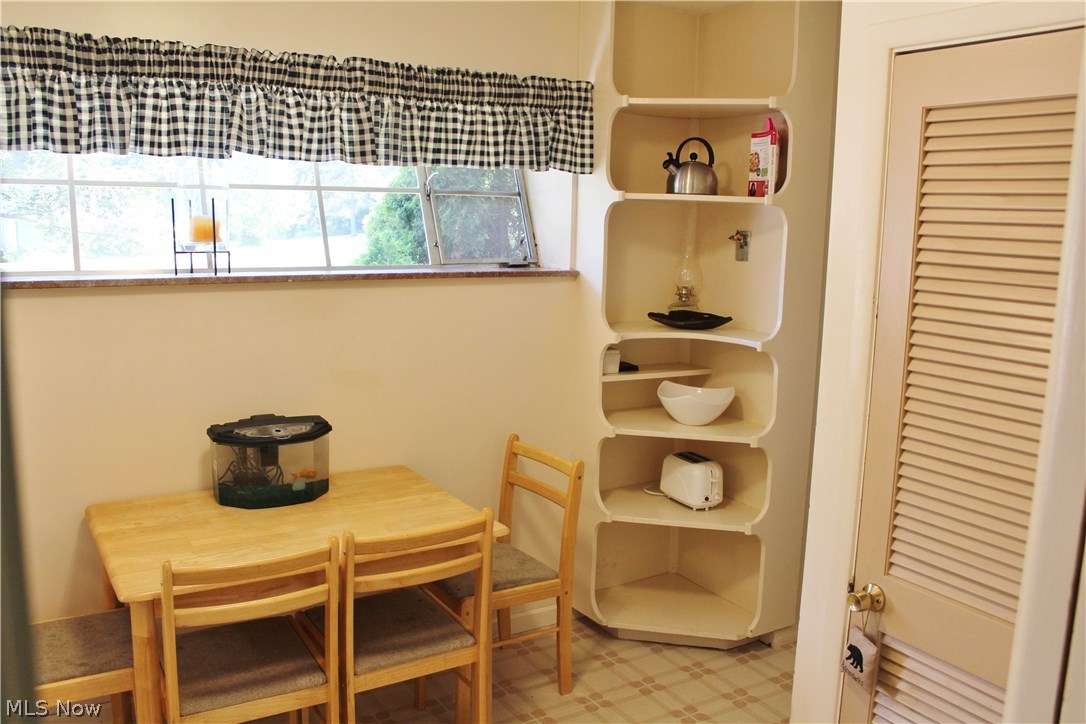 1825 Walnut Road Kent, OH 44240 - Photo 9 of 23 This is the eating area of the kitchen. Aren't the built in shelves adorable? Behind the louvered door is a deep pantry. The window really does slant. Not an optical illusion!