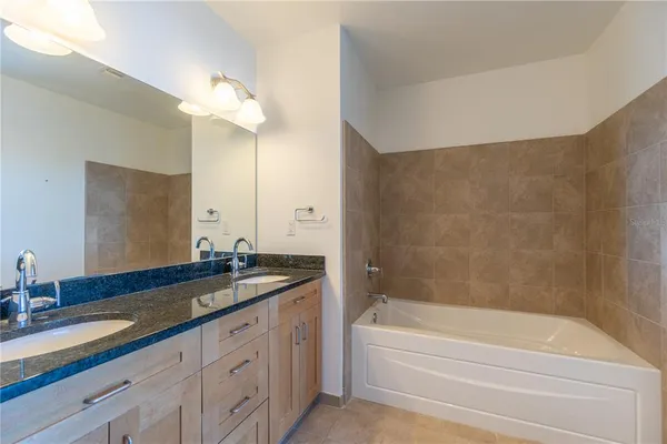 a bathroom with a double vanity sink and a mirror