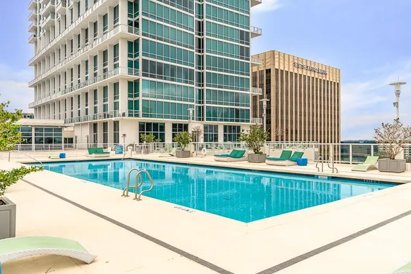 a living room with furniture pool table and a large window
