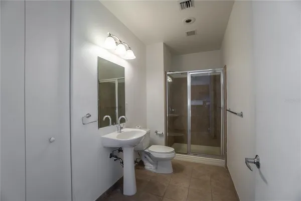 a bathroom with a toilet sink and shower