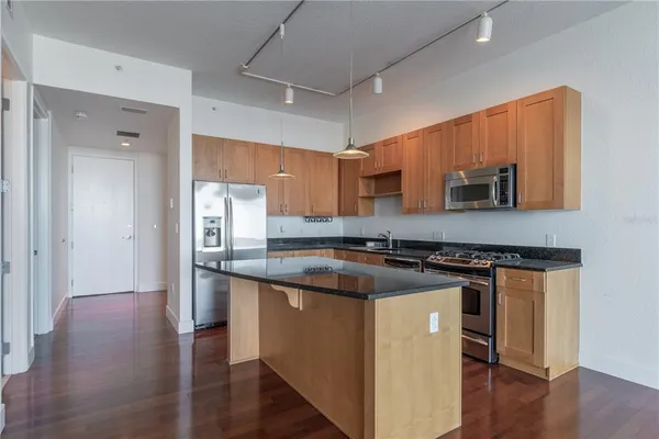 a kitchen with stainless steel appliances granite countertop a stove and a sink