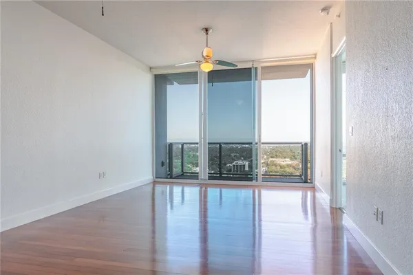 an empty room with wooden floor and fireplace