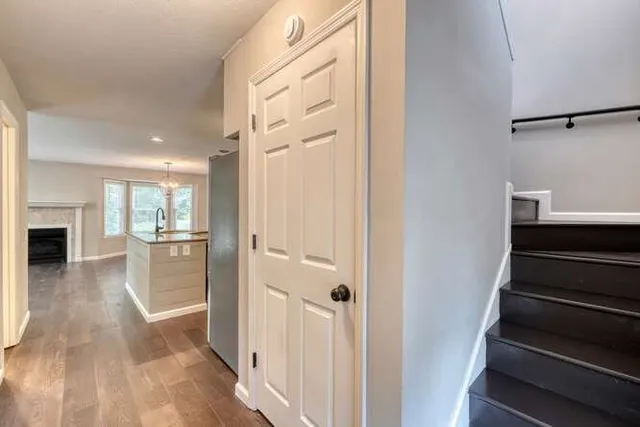 a view of a hallway view with wooden floor and staircase