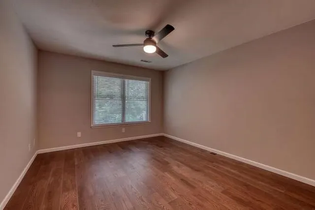 a view of an empty room and wooden floor