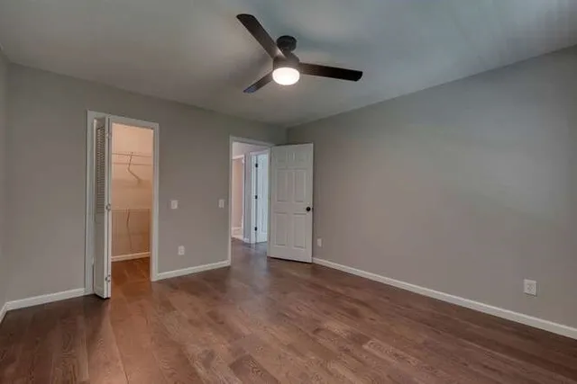 a bathroom with a granite countertop double vanity sink a mirror and a bathtub