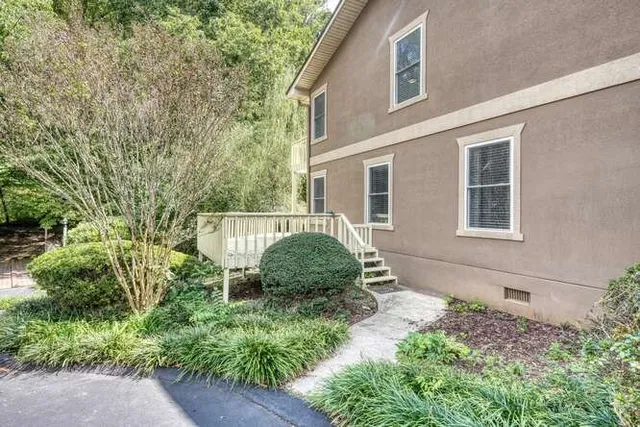 a view of a house with backyard and balcony