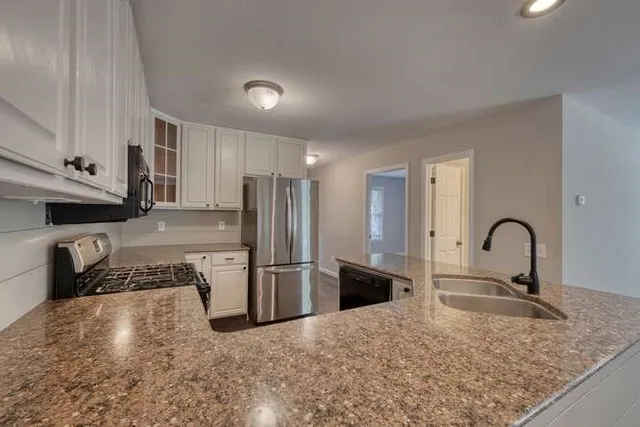 a kitchen with refrigerator and stove