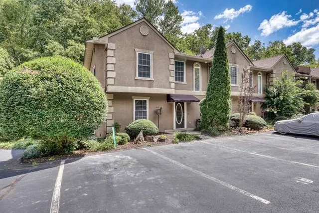 a front view of a house with a yard and a garage