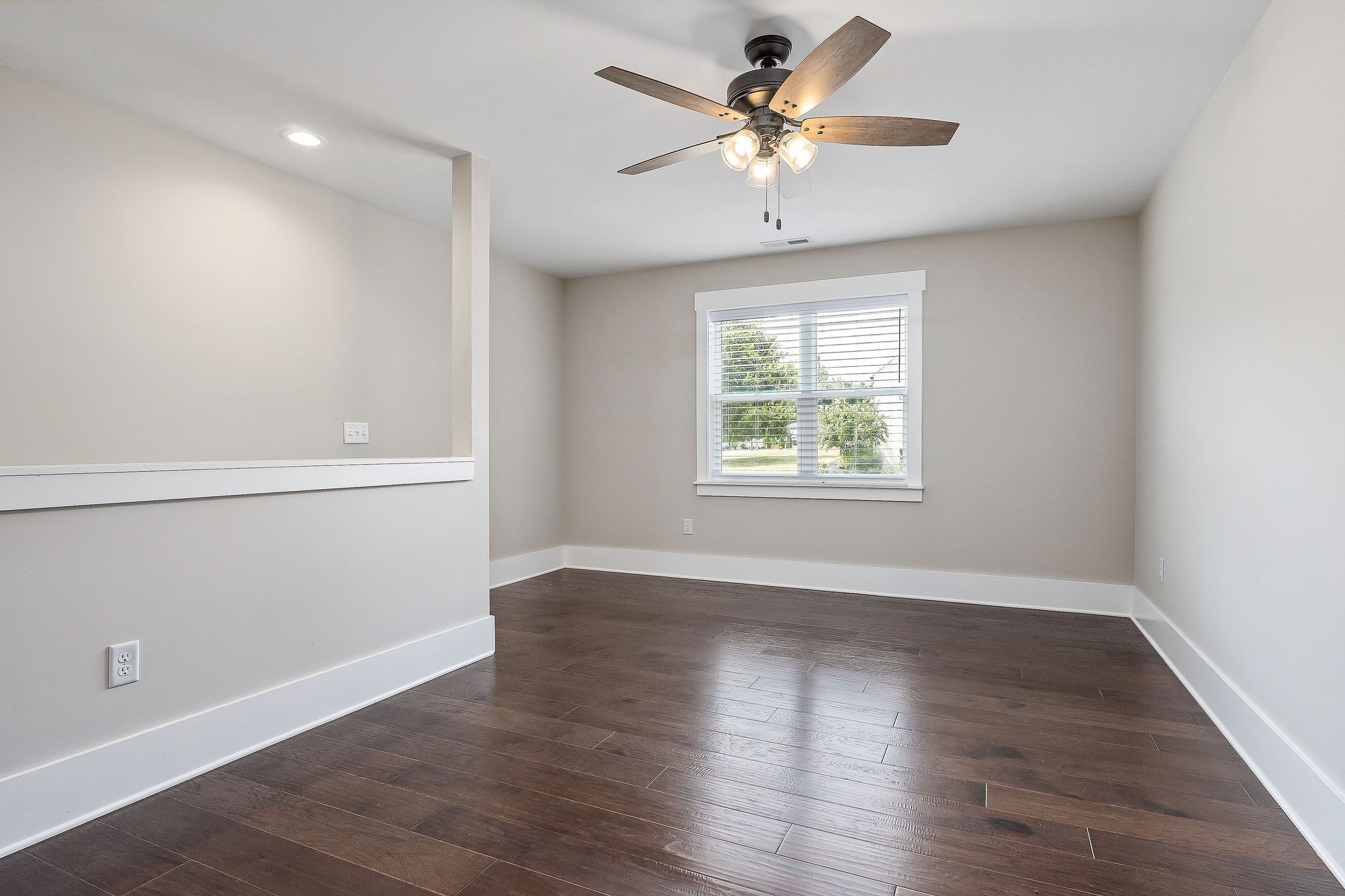 733 Jackson Avenue Carthage, TN 37030 - Photo 11 of 47 an empty room with wooden floor chandelier fan and windows