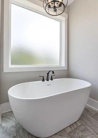 a white bath tub sitting next to a white sink