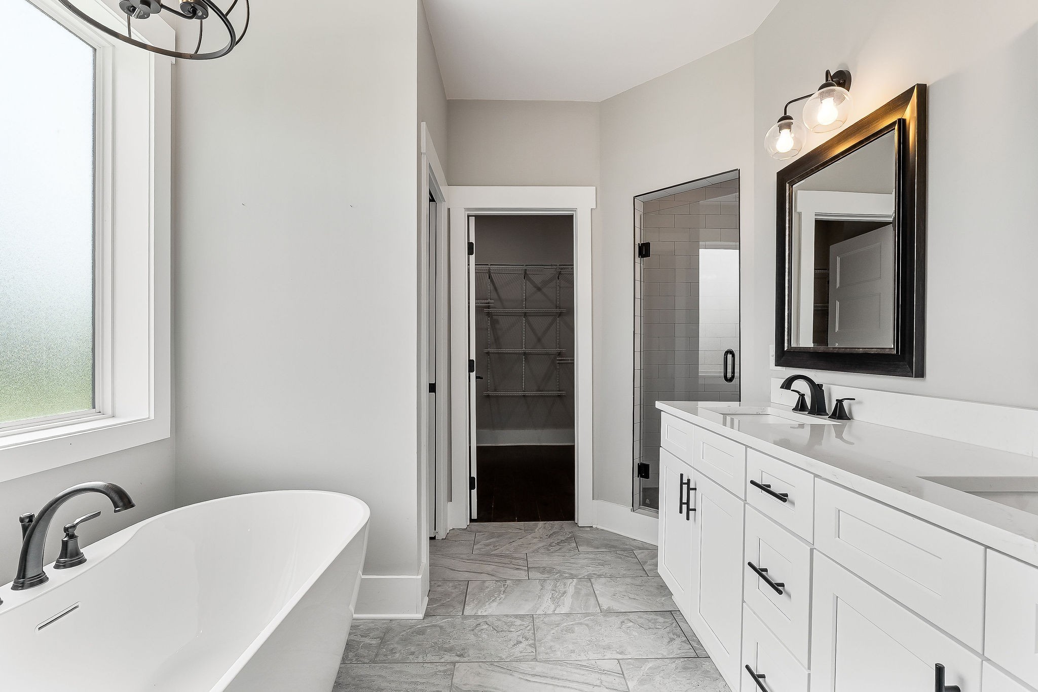 733 Jackson Avenue Carthage, TN 37030 - Photo 17 of 47 a bathroom with a double vanity sink a mirror and a bathtub