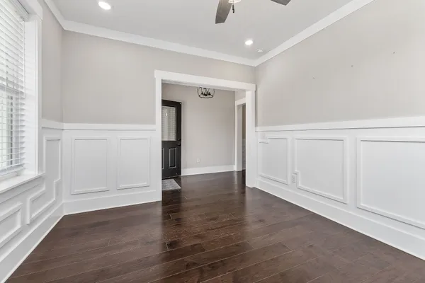 an empty room with wooden floor & closet and windows