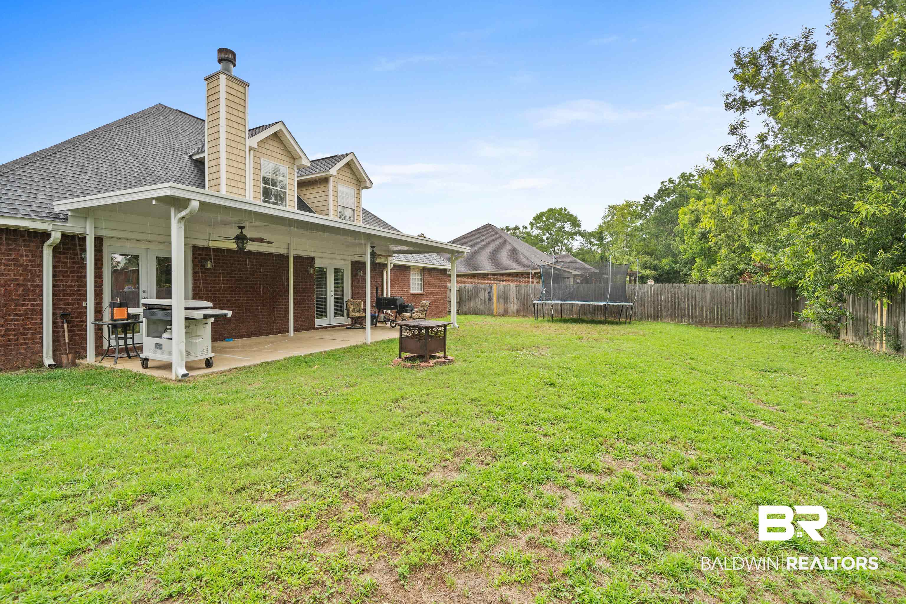 9552 Collier Loop Daphne, AL 36526 - Photo 26 of 28 View of yard featuring ceiling fan, a trampoline, french doors, and a patio