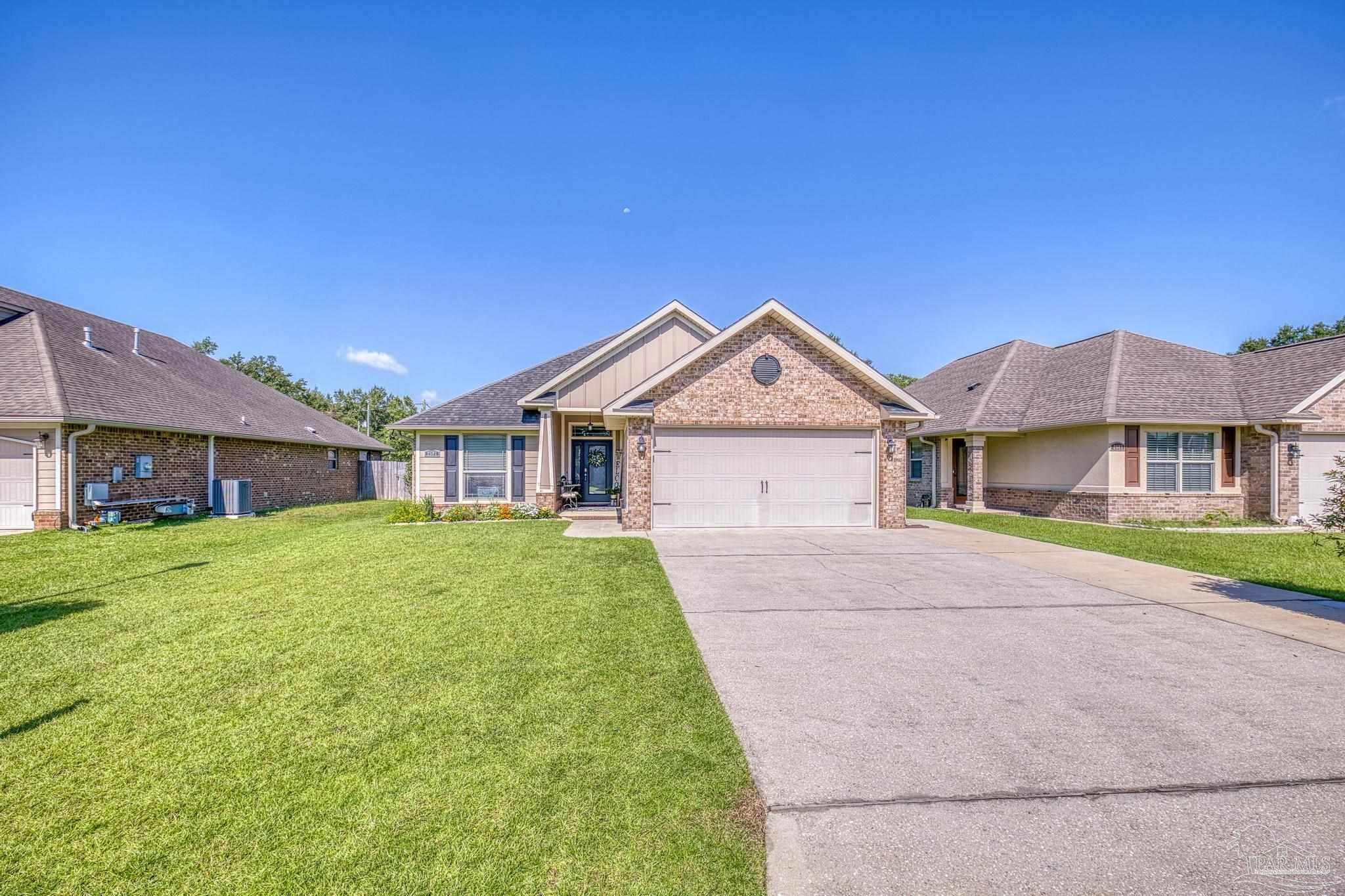 2587 Fiddlers Circle Cantonment, FL 32533 - Photo 1 of 66 a front view of a house with a yard